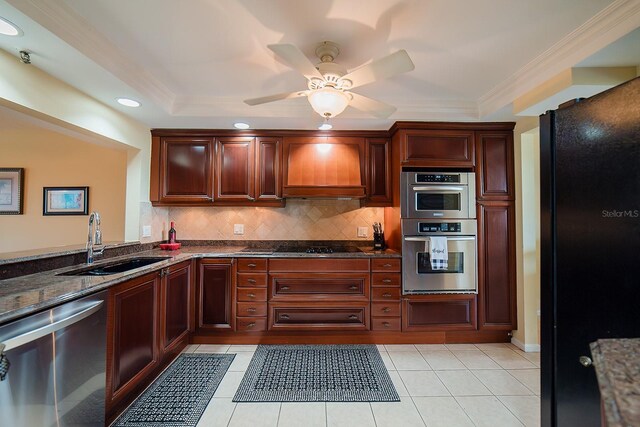 7303 Jessie Harbor Dr Unit 7303, Osprey, FL 34229 - kitchen with appliances with stainless steel finishes, premium range hood, decorative backsplash, ceiling fan, and crown molding