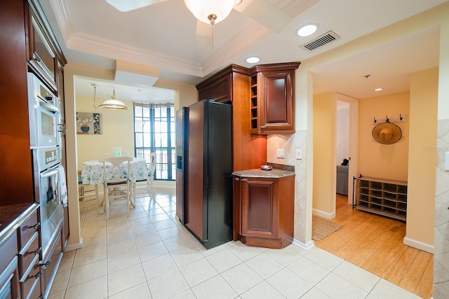 7303 Jessie Harbor Dr Unit 7303, Osprey, FL 34229 - kitchen with fridge with ice dispenser, ornamental molding, backsplash, light tile patterned floors, and recessed lighting