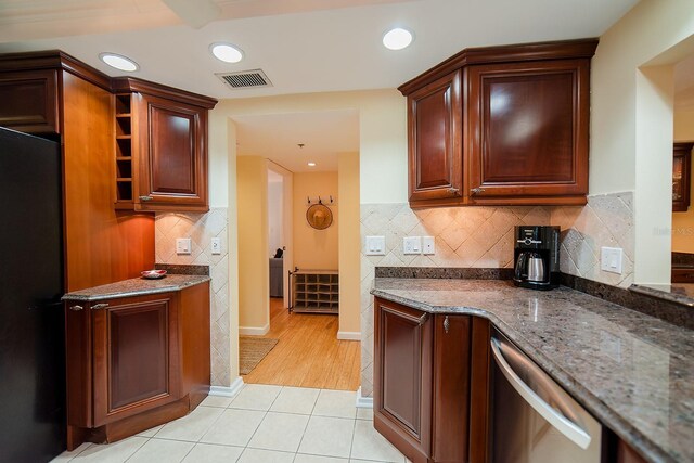 7303 Jessie Harbor Dr Unit 7303, Osprey, FL 34229 - kitchen with dishwasher, light tile patterned flooring, dark stone countertops, tasteful backsplash, and recessed lighting