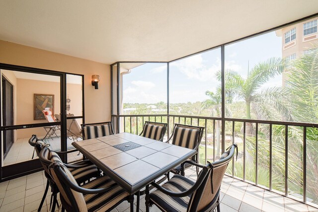 7303 Jessie Harbor Dr Unit 7303, Osprey, FL 34229 - sunroom / solarium featuring tile patterned floors and expansive windows