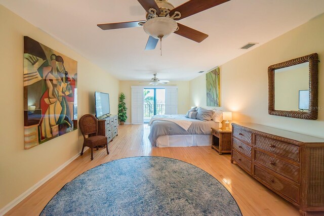 7303 Jessie Harbor Dr Unit 7303, Osprey, FL 34229 - bedroom featuring light wood-type flooring, a ceiling fan, and access to outside