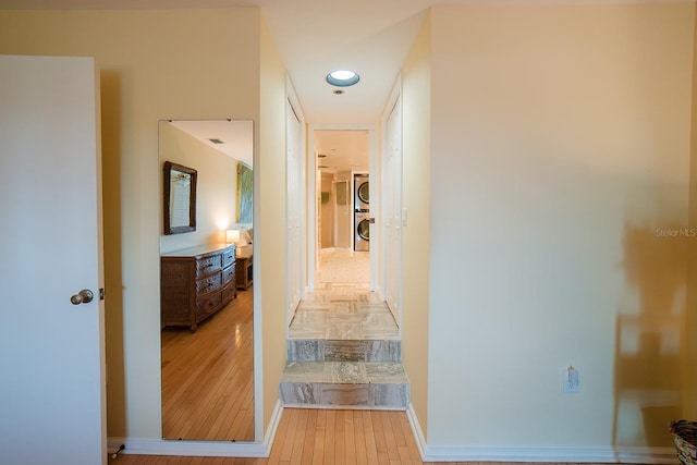 7303 Jessie Harbor Dr Unit 7303, Osprey, FL 34229 - hall featuring stacked washing machine and dryer and light wood-type flooring