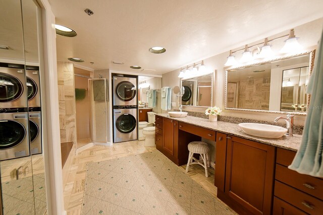 7303 Jessie Harbor Dr Unit 7303, Osprey, FL 34229 - full bath with stacked washer / dryer, a stall shower, double vanity, and recessed lighting