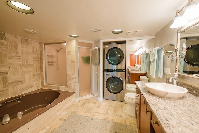 7303 Jessie Harbor Dr Unit 7303, Osprey, FL 34229 - bathroom with stacked washer / dryer, a shower stall, vanity, a tub with jets, and recessed lighting