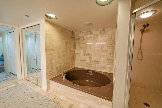 7303 Jessie Harbor Dr Unit 7303, Osprey, FL 34229 - full bathroom featuring a whirlpool tub and a shower stall