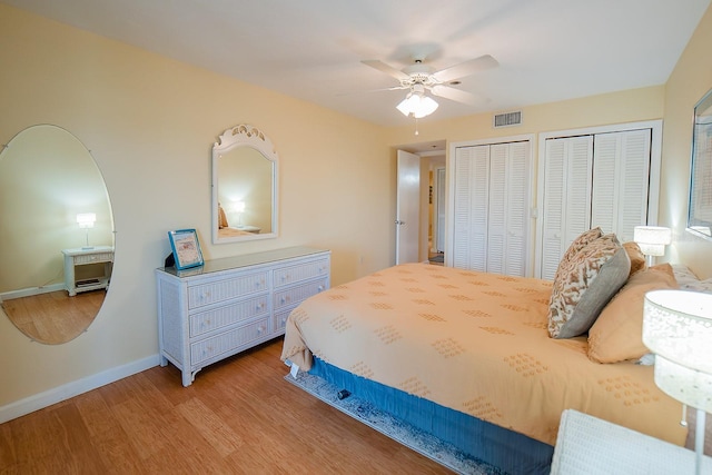 7303 Jessie Harbor Dr Unit 7303, Osprey, FL 34229 - bedroom featuring multiple closets, wood finished floors, and ceiling fan