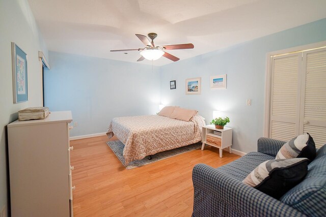 7303 Jessie Harbor Dr Unit 7303, Osprey, FL 34229 - bedroom with light wood-style flooring, a closet, and ceiling fan