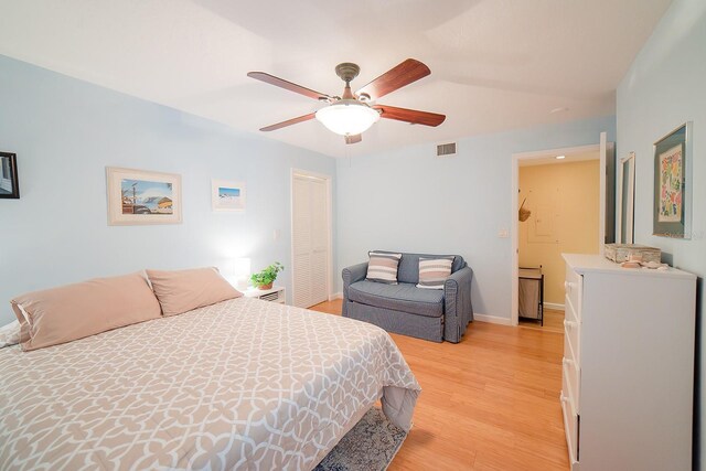 7303 Jessie Harbor Dr Unit 7303, Osprey, FL 34229 - bedroom featuring light wood finished floors, ceiling fan, and a closet