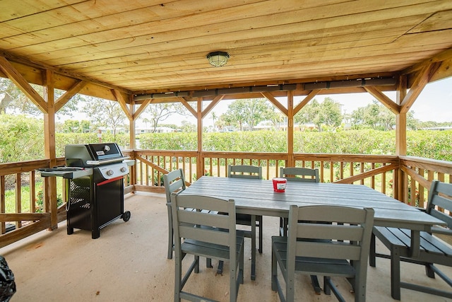 7303 Jessie Harbor Dr Unit 7303, Osprey, FL 34229 - deck featuring a grill and outdoor dining area
