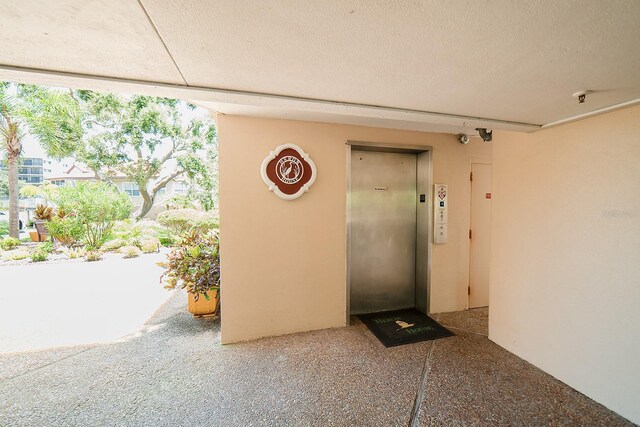 7303 Jessie Harbor Dr Unit 7303, Osprey, FL 34229 - view of exterior entry featuring elevator and stucco siding