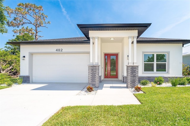482 Sunset Rd N, Rotonda West, FL 33947 - view of front of property with concrete driveway, a front lawn, stucco siding, and a garage