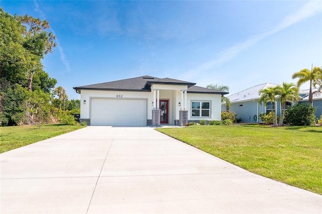 482 Sunset Rd N, Rotonda West, FL 33947 - prairie-style house with stucco siding, a garage, driveway, and a front lawn