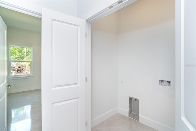 482 Sunset Rd N, Rotonda West, FL 33947 - washroom with washer hookup, light tile patterned floors, baseboards, and electric dryer hookup