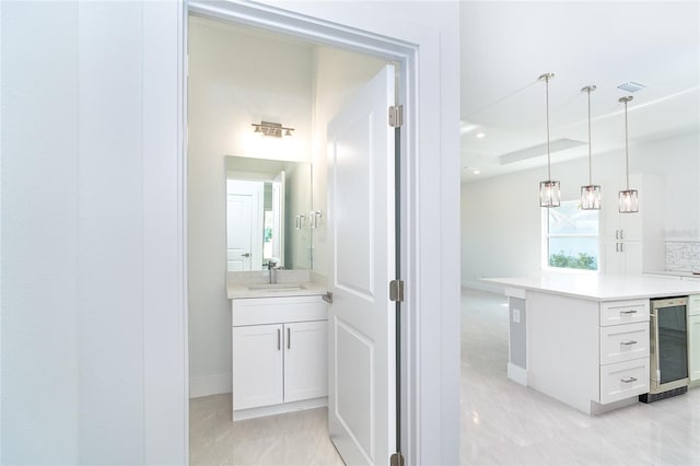 482 Sunset Rd N, Rotonda West, FL 33947 - hallway featuring wine cooler, a sink, baseboards, and a raised ceiling