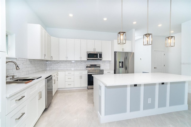 482 Sunset Rd N, Rotonda West, FL 33947 - kitchen with stainless steel appliances, a sink, a kitchen island, decorative backsplash, and light countertops