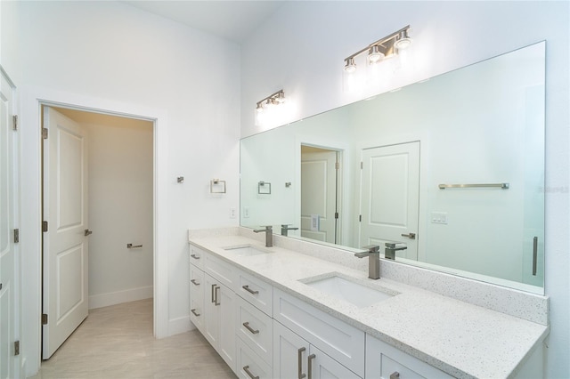482 Sunset Rd N, Rotonda West, FL 33947 - bathroom featuring double vanity and baseboards