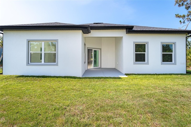 482 Sunset Rd N, Rotonda West, FL 33947 - back of house with stucco siding, a yard, a patio area, and roof with shingles