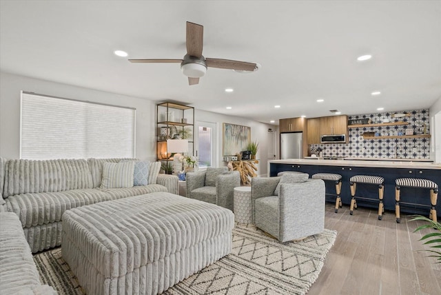 7530 Whitcomb St, Englewood, FL 34223 - living area with light wood-style flooring, ceiling fan, and recessed lighting