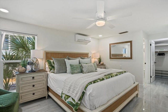 7530 Whitcomb St, Englewood, FL 34223 - bedroom featuring an AC wall unit, recessed lighting, ceiling fan, baseboards, and a walk in closet