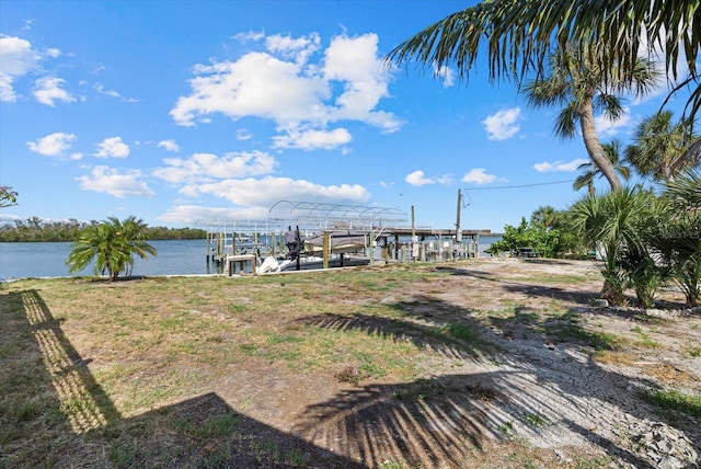 7530 Whitcomb St, Englewood, FL 34223 - view of yard featuring boat lift, a water view, and a dock