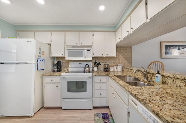 1501 Beach Rd Unit 310, Englewood, FL 34223 - kitchen with white appliances, a sink, light wood-style floors, white cabinetry, and ornamental molding