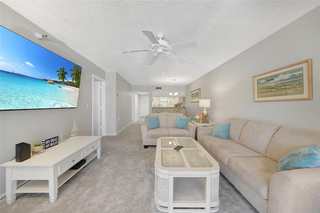 1501 Beach Rd Unit 310, Englewood, FL 34223 - living room featuring a ceiling fan, light colored carpet, a textured ceiling, and baseboards