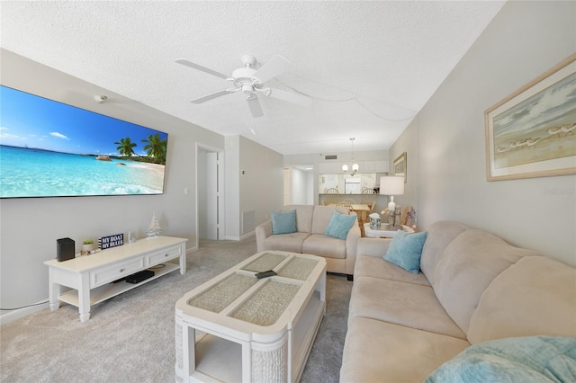 1501 Beach Rd Unit 310, Englewood, FL 34223 - carpeted living room featuring ceiling fan, a textured ceiling, and a chandelier