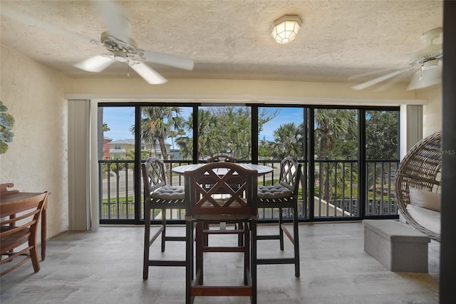 1501 Beach Rd Unit 310, Englewood, FL 34223 - dining area with a ceiling fan, plenty of natural light, a textured ceiling, and a textured wall