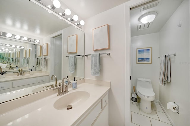 1501 Beach Rd Unit 310, Englewood, FL 34223 - full bath with tile patterned flooring, vanity, toilet, and baseboards
