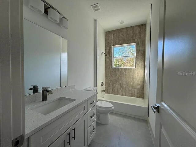 311 Yule St, Port Charlotte, FL 33953 - full bathroom with vanity, toilet, washtub / shower combination, and tile patterned flooring