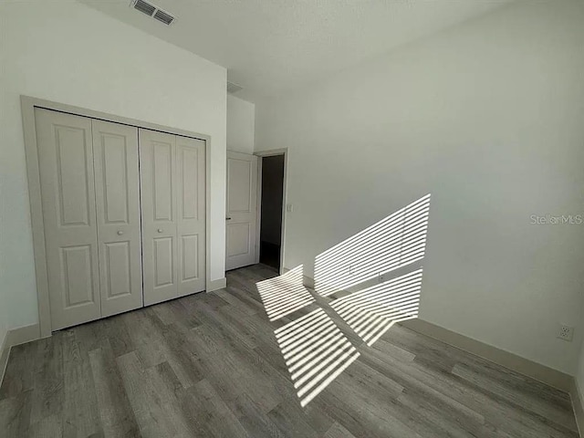 311 Yule St, Port Charlotte, FL 33953 - unfurnished bedroom featuring wood finished floors, a closet, and baseboards