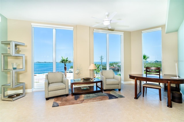 1375 Beach Rd Unit 201, Englewood, FL 34223 - living area with a ceiling fan, baseboards, light tile patterned floors, and a water view