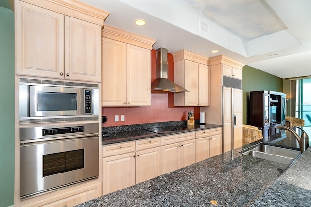 1375 Beach Rd Unit 201, Englewood, FL 34223 - kitchen with built in appliances, wall chimney range hood, a sink, recessed lighting, and dark stone countertops