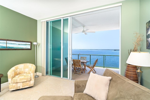 1375 Beach Rd Unit 201, Englewood, FL 34223 - tiled living room featuring a wall of windows, a water view, a ceiling fan, and baseboards
