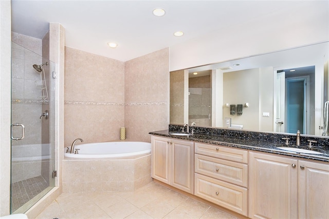 1375 Beach Rd Unit 201, Englewood, FL 34223 - bathroom featuring a shower stall, a garden tub, double vanity, tile patterned floors, and recessed lighting