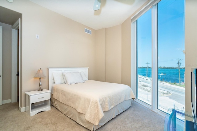 1375 Beach Rd Unit 201, Englewood, FL 34223 - bedroom with light colored carpet, access to exterior, baseboards, and ceiling fan