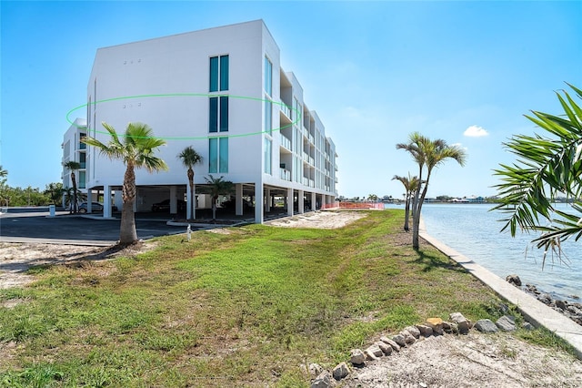 1375 Beach Rd Unit 201, Englewood, FL 34223 - view of building exterior with a carport and a water view