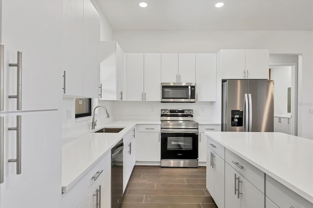 10242 Hallendale Dr, Port Charlotte, FL 33981 - kitchen with stainless steel appliances, a sink, recessed lighting, light countertops, and white cabinetry