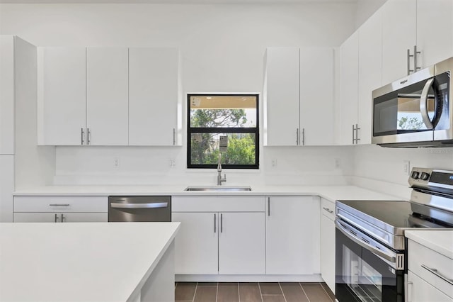10242 Hallendale Dr, Port Charlotte, FL 33981 - kitchen featuring stainless steel appliances, a sink, light countertops, and white cabinetry