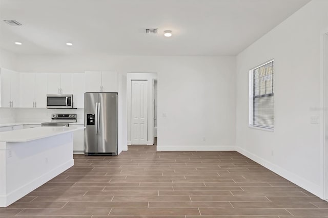 10242 Hallendale Dr, Port Charlotte, FL 33981 - kitchen featuring stainless steel appliances, wood finished floors, light countertops, baseboards, and recessed lighting