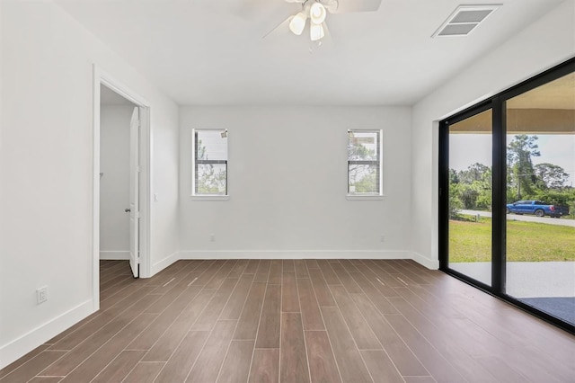 10242 Hallendale Dr, Port Charlotte, FL 33981 - unfurnished room with a ceiling fan, baseboards, and dark wood-type flooring