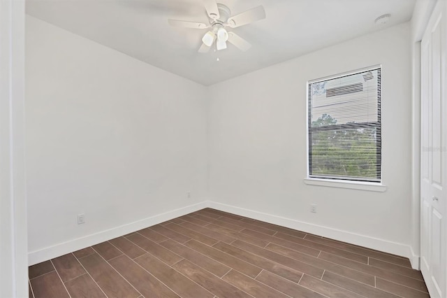 10242 Hallendale Dr, Port Charlotte, FL 33981 - empty room with baseboards, dark wood-type flooring, a ceiling fan, and a smoke detector