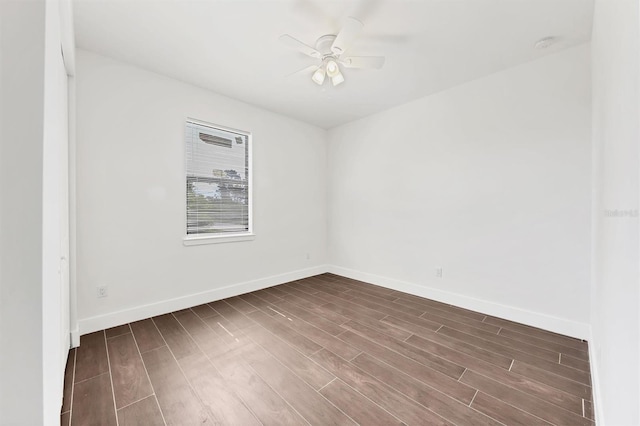 10242 Hallendale Dr, Port Charlotte, FL 33981 - empty room featuring dark wood-type flooring, a ceiling fan, and baseboards