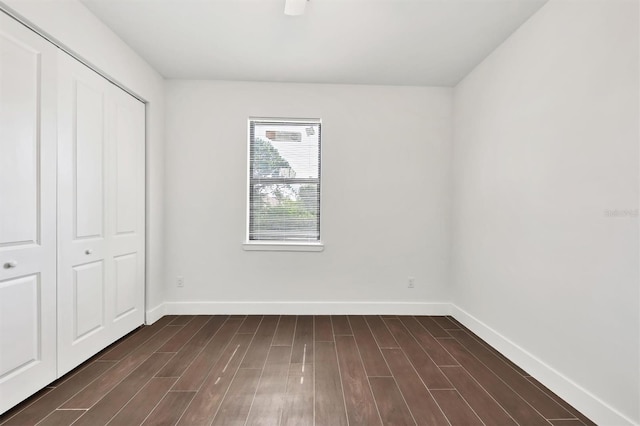 10242 Hallendale Dr, Port Charlotte, FL 33981 - unfurnished bedroom featuring baseboards, dark wood finished floors, and a closet
