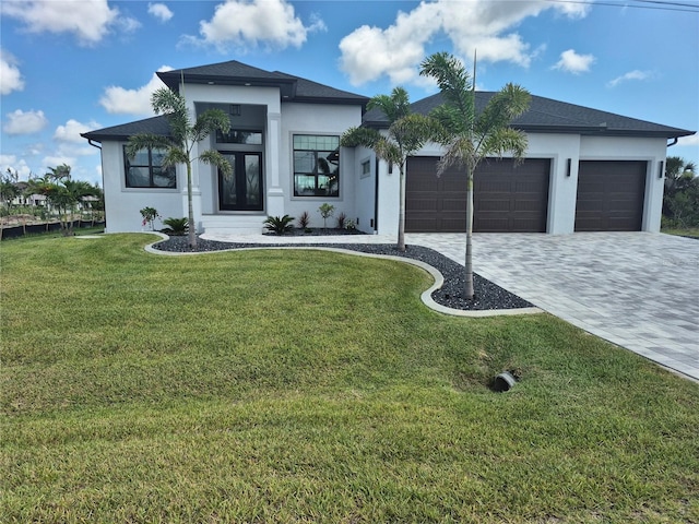 10454 Atenia St, Port Charlotte, FL 33981 - view of front of home featuring stucco siding, decorative driveway, an attached garage, a front lawn, and french doors