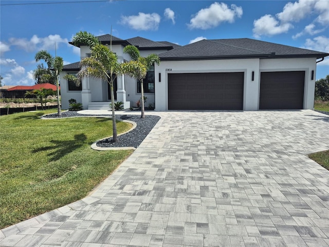 10454 Atenia St, Port Charlotte, FL 33981 - view of front of home with an attached garage, decorative driveway, a front yard, and stucco siding