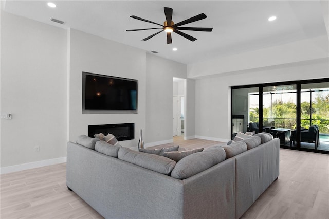 10454 Atenia St, Port Charlotte, FL 33981 - living area with light wood-style flooring, baseboards, a glass covered fireplace, recessed lighting, and ceiling fan