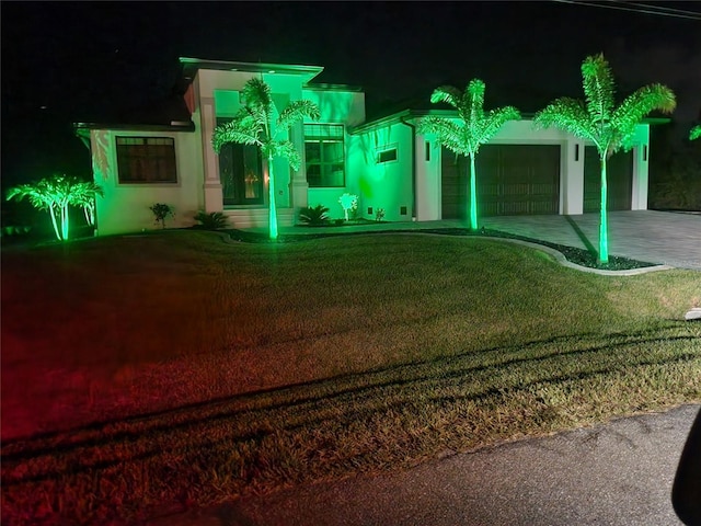10454 Atenia St, Port Charlotte, FL 33981 - view of front of home featuring a garage, concrete driveway, a yard, and stucco siding