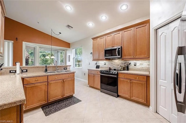 13091 Sandy Key Bnd Unit 104, North Fort Myers, FL 33903 - kitchen with black range oven, a sink, stainless steel microwave, lofted ceiling, and backsplash