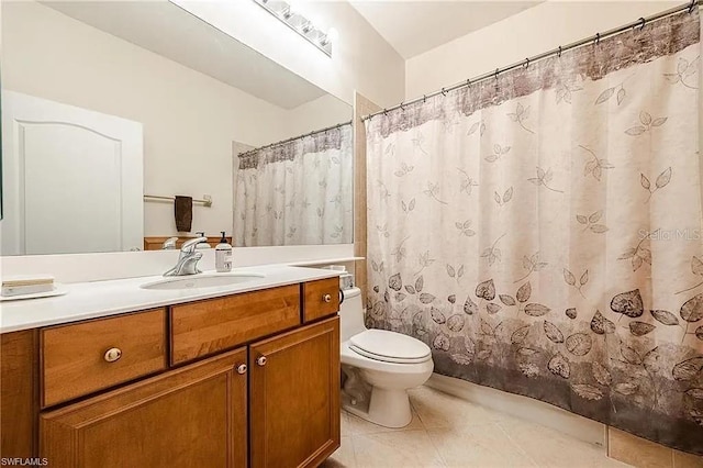 13091 Sandy Key Bnd Unit 104, North Fort Myers, FL 33903 - bathroom featuring toilet, vanity, tile patterned floors, and a shower with shower curtain